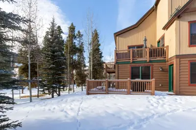 a house with a deck in the snow at Red Hawk Townhomes by Summit County Mountain Retreats in Keystone