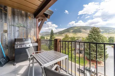 a balcony with a table and a stove at Sail Lofts by Summit County Mountain Retreats in Dillon