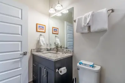 a bathroom with a sink and a toilet and a mirror at Sail Lofts by Summit County Mountain Retreats in Dillon