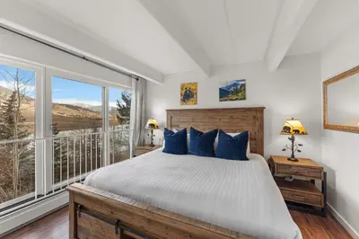a bedroom with a bed and a large window at The Lodge at Lake Dillon 111 in Dillon