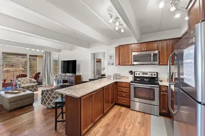 a kitchen with wooden cabinets and stainless steel appliances at The Lodge at Lake Dillon 111 in Dillon
