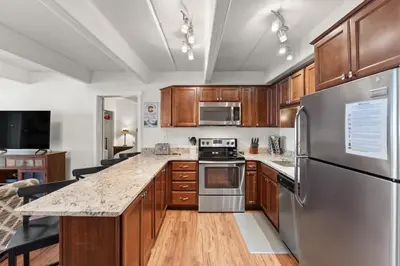 a kitchen with wooden cabinets and stainless steel appliances at The Lodge at Lake Dillon 111 in Dillon