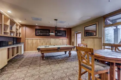 a game room with a pool table and a bar at Silver Mill by Summit County Mountain Retreats in Keystone