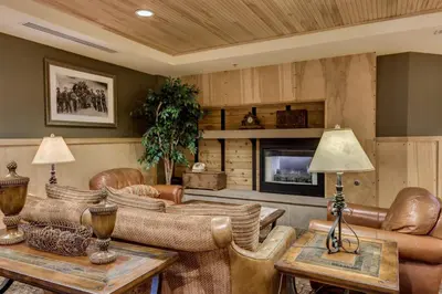 a living room with leather furniture and a fireplace at Silver Mill by Summit County Mountain Retreats in Keystone