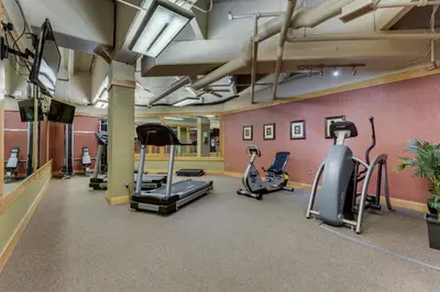 a gym with several treadmills and elliptical machines at Silver Mill by Summit County Mountain Retreats in Keystone