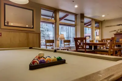 a billiard table with a box of balls on it at Silver Mill by Summit County Mountain Retreats in Keystone