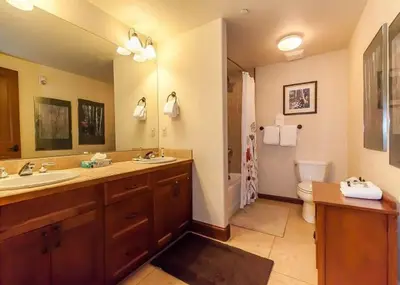 a bathroom with a sink and a toilet and a mirror at Oro Grande by Summit County Mountain Retreats in Keystone