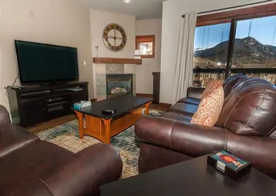 a living room with leather furniture and a flat screen tv at Oro Grande by Summit County Mountain Retreats in Keystone