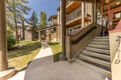 a house with stairs to the front of it at Pines by Summit County Mountain Retreats in Keystone