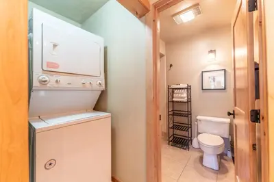 a small bathroom with a toilet and a sink at Pines by Summit County Mountain Retreats in Keystone