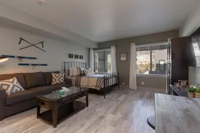 a living room with a couch and a table at Slopeside by Summit County Mountain Retreats in Keystone