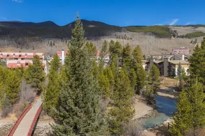 an aerial view of a resort with trees and a river at Slopeside by Summit County Mountain Retreats in Keystone