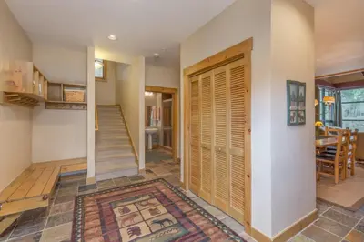 a hallway with a wooden door in a house at Ski Tip by Summit County Mountain Retreats in Keystone