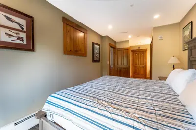 a bedroom with a large bed in a room at Springs by Summit County Mountain Retreats in Keystone