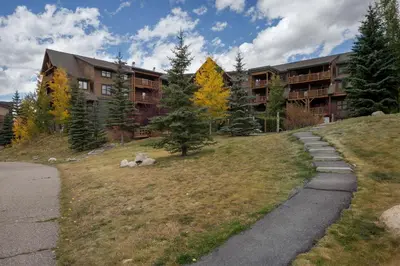 a building on a hill next to a road at Tenderfoot Lodge by Summit County Mountain Retreats in Keystone
