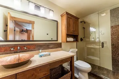 a bathroom with a sink and a toilet and a shower at Tenderfoot Lodge by Summit County Mountain Retreats in Keystone
