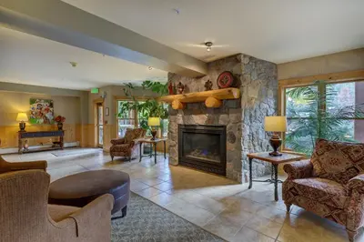a large living room with a stone fireplace at Tenderfoot Lodge by Summit County Mountain Retreats in Keystone