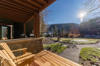 a porch with two wooden chairs on a house at Tenderfoot Lodge by Summit County Mountain Retreats in Keystone