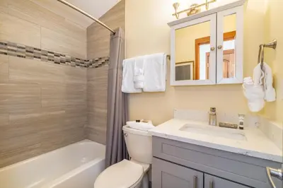 a bathroom with a toilet and a sink and a tub at Tennis Townhome 1337 : 2 in Keystone