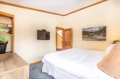 a bedroom with a bed and a flat screen tv at Tennis Townhome 1337 : 2 in Keystone