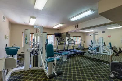 a gym with treadmills and machines in a room at Gateway by Summit County Mountain Retreats in Keystone