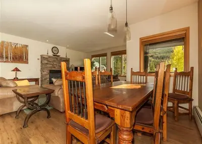 a dining room with a wooden table and chairs at Gateway by Summit County Mountain Retreats in Keystone