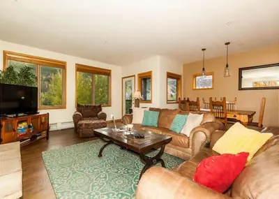 a living room with a couch and a tv at Gateway by Summit County Mountain Retreats in Keystone