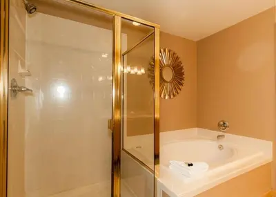 a bathroom with a shower and a tub and a sink at Gateway by Summit County Mountain Retreats in Keystone