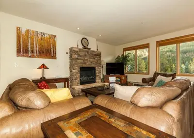 a living room with two couches and a fireplace at Gateway by Summit County Mountain Retreats in Keystone