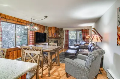 a dining room and living room with a table and chairs at Condo with Pool Access 2 Mi to Winter Park Resort! in Winter Park