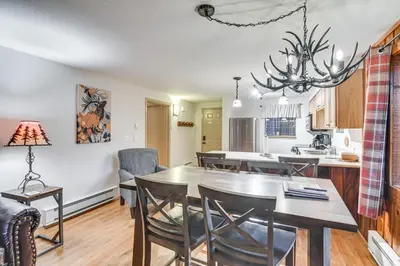 a kitchen and dining room with a table and chairs at Condo with Pool Access 2 Mi to Winter Park Resort! in Winter Park