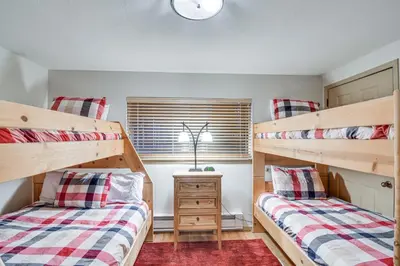 a bedroom with two bunk beds and a window at Condo with Pool Access 2 Mi to Winter Park Resort! in Winter Park
