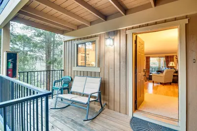 a porch with two chairs sitting on it at Condo with Pool Access 2 Mi to Winter Park Resort! in Winter Park