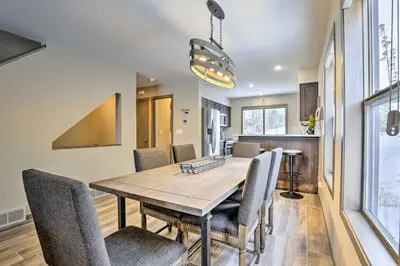 a dining room with a wooden table and chairs at 8 Mi to Copper Mtn Sleek Frisco Townhome with Views in Frisco