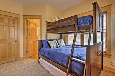 a bedroom with two bunk beds in a room at Fish, Hike and Ski Riverfront Granby Cabin! in Granby