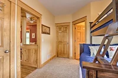 a bedroom with a bunk bed and a closet at Fish, Hike and Ski Riverfront Granby Cabin! in Granby