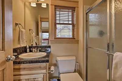 a bathroom with a toilet and a sink and a shower at Fish, Hike and Ski Riverfront Granby Cabin! in Granby