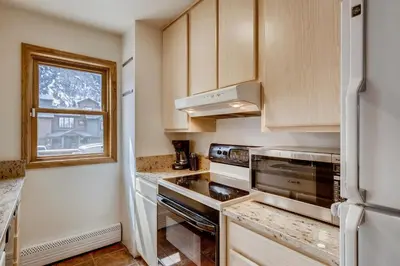a kitchen with white appliances and a window at Mount Royal Condos #501 condo in Frisco