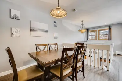 a dining room with a wooden table and chairs at Mount Royal Condos #501 condo in Frisco