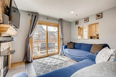 a living room with a blue couch and a window at Mount Royal Condos #501 condo in Frisco