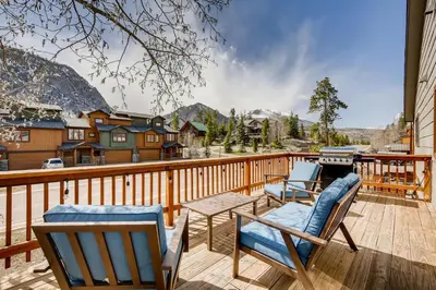 a deck with two chairs and a table and a grill at Mount Royal Condos #501 condo in Frisco