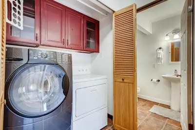 a laundry room with a washing machine and a sink at Mount Royal Condos #501 condo in Frisco