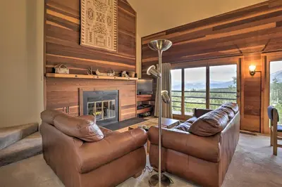 a living room with two leather couches and a fireplace at Resort Perks and Trail Access Silverthorne Condo! in Silverthorne