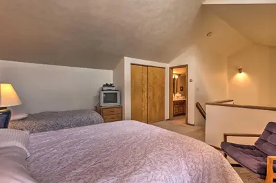 a bedroom with two beds and a tv in it at Resort Perks and Trail Access Silverthorne Condo! in Silverthorne