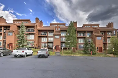 a large brick building with cars parked in a parking lot at Resort Perks and Trail Access Silverthorne Condo! in Silverthorne