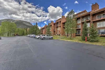 a parking lot with cars parked in front of a building at Resort Perks and Trail Access Silverthorne Condo! in Silverthorne