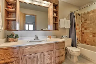 a bathroom with a sink and a toilet and a mirror at Resort Perks and Trail Access Silverthorne Condo! in Silverthorne