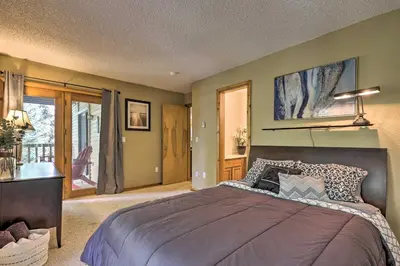 a bedroom with a large bed and a balcony at Cozy Condo on Vasquez Creek with Free Shuttle Access in Winter Park