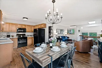 a kitchen and dining room with a table and chairs at Horsetooth Stoop Trails, Lake Access and Mountain Views in Fort Collins