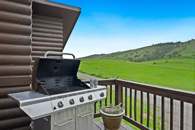 a grill on a balcony with a view of a field at Horsetooth Stoop Trails, Lake Access and Mountain Views in Fort Collins
